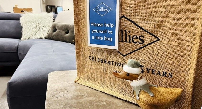 Gillies jute bag on side table with blue sofa in the background