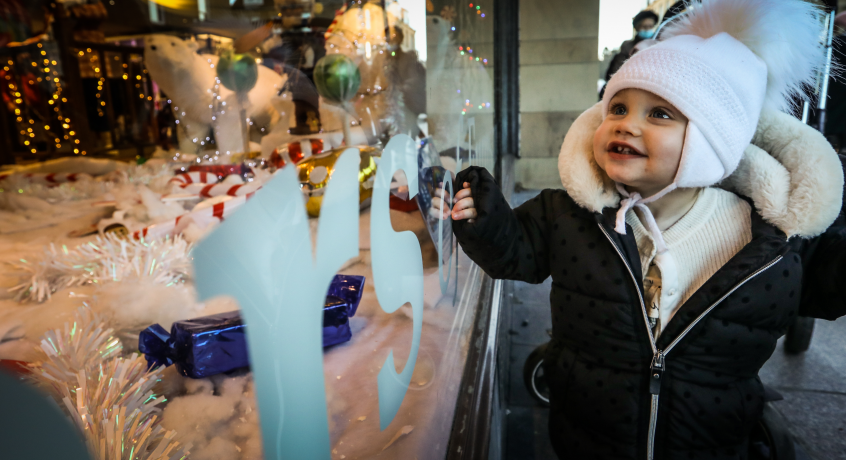 child stares in wonder at the christmas display