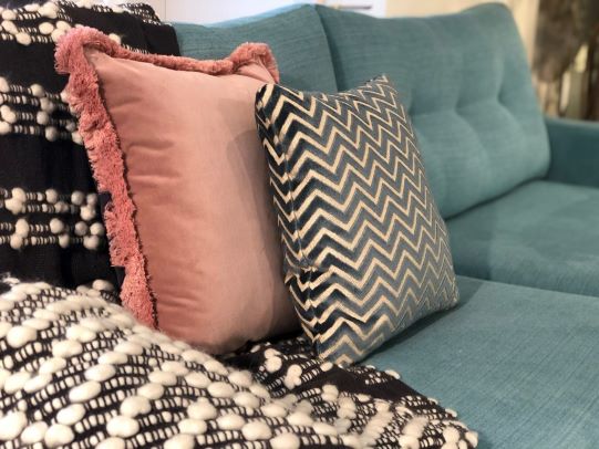 close up of a blue sofa with cushions